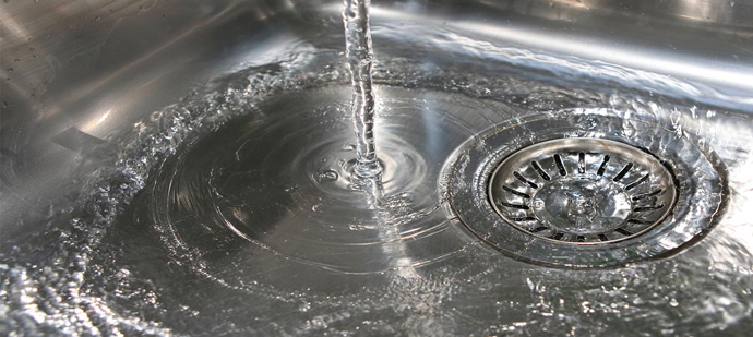 Closeup of water flowing into a drain