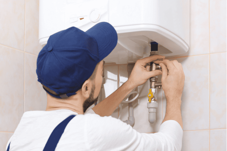 A plumber repairing a water heater