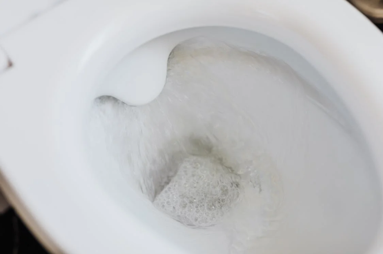  A toilet being flushed 
