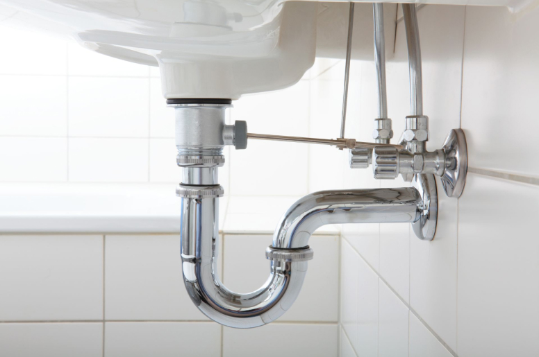  The P-trap and water supply lines on the underside of a sink