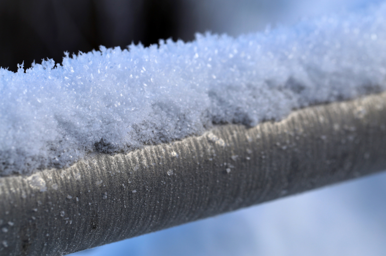 a close-up of a pipe with snow on its surface 